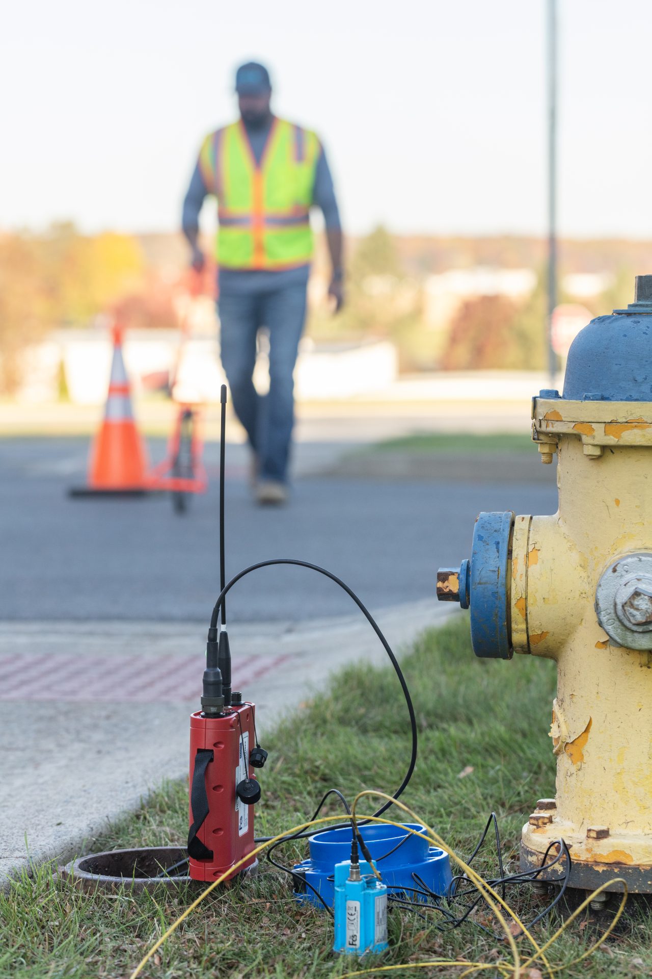 Guy performing a leak correlation test during a commercial leak detection