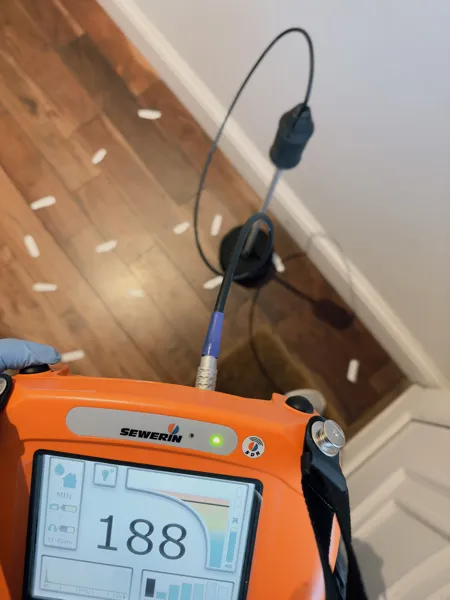 Residential leak detection being performed with a non-invasive acoustic device